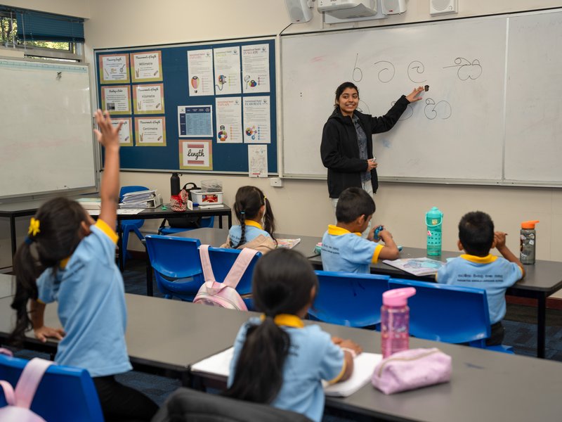 A student raising her hand during class