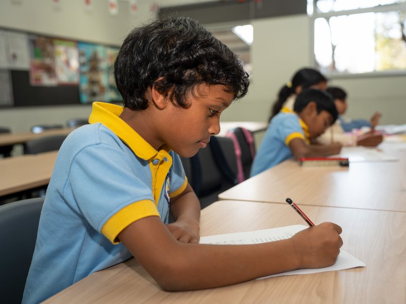A student concentrating on his writing