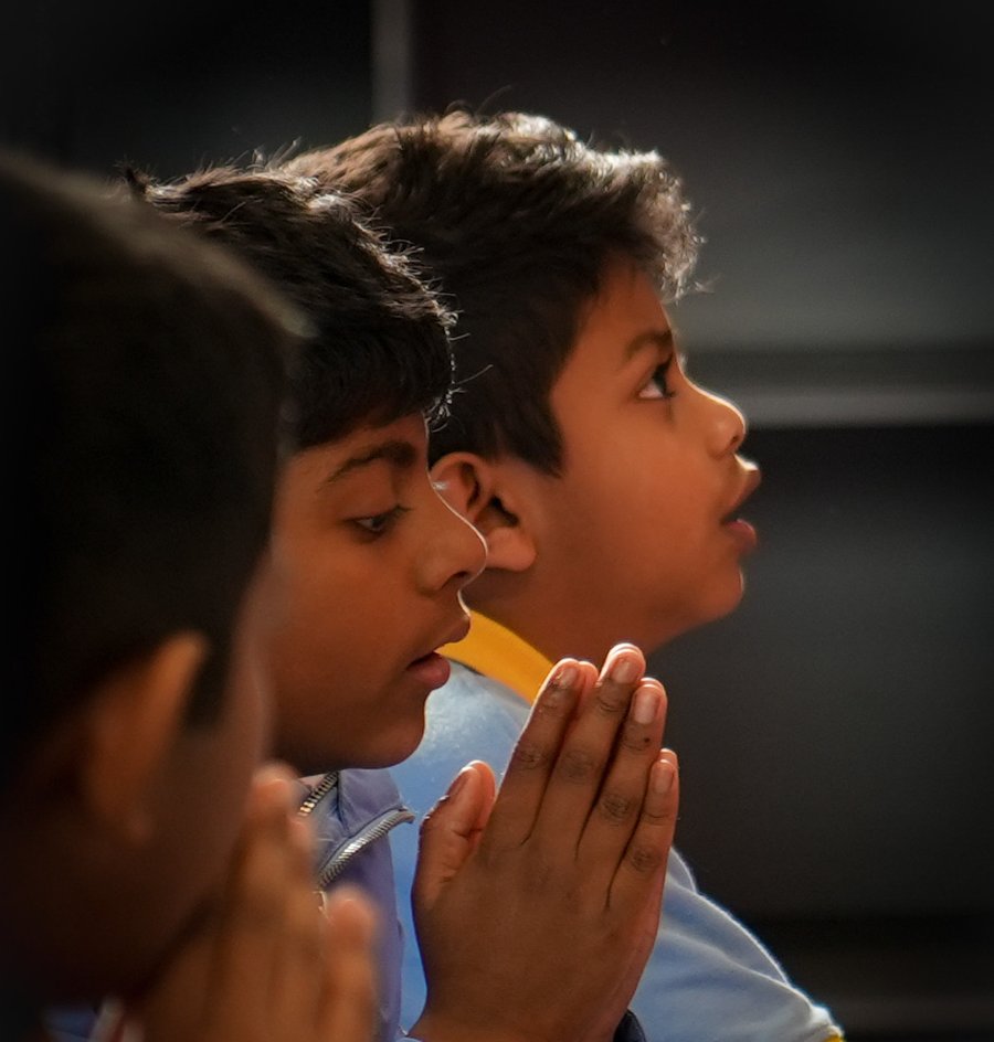 Students in quiet reflection during a school ceremony at Paramitha Sinhala Language School